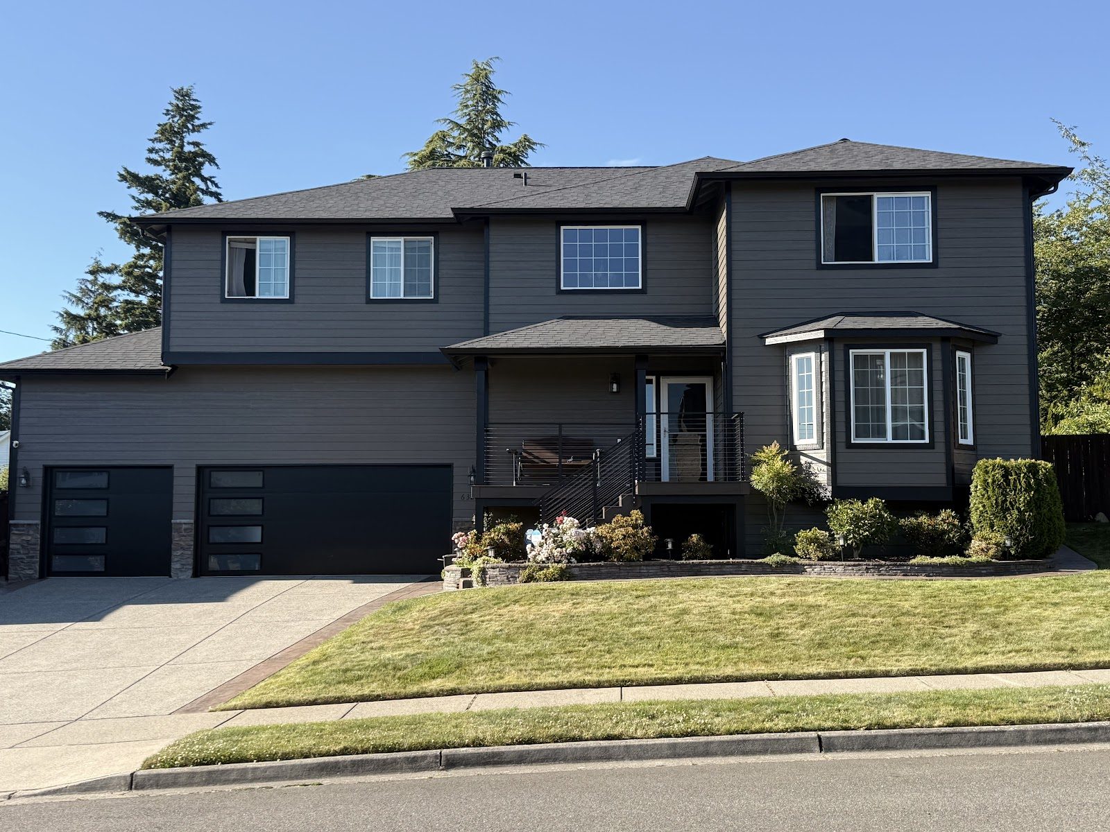 Full exterior repaint in deep charcoal with crisp white trim