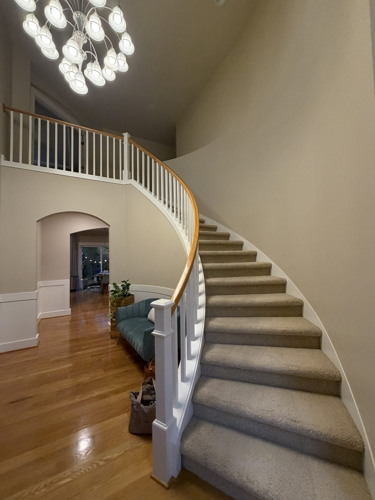 Curved stairwell interior with freshly painted walls and railing